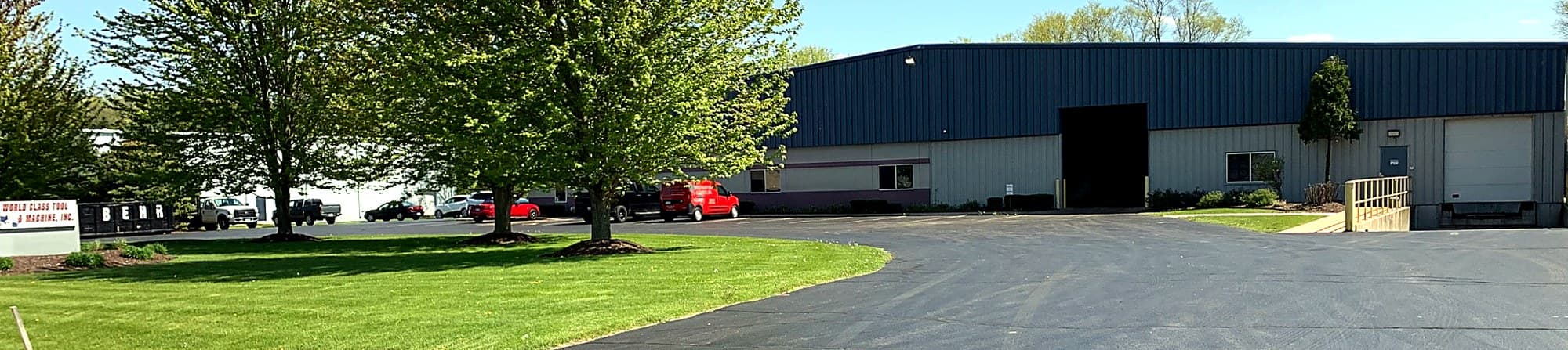 Panoramic exterior banner of the World Class Tool & Machine facility.