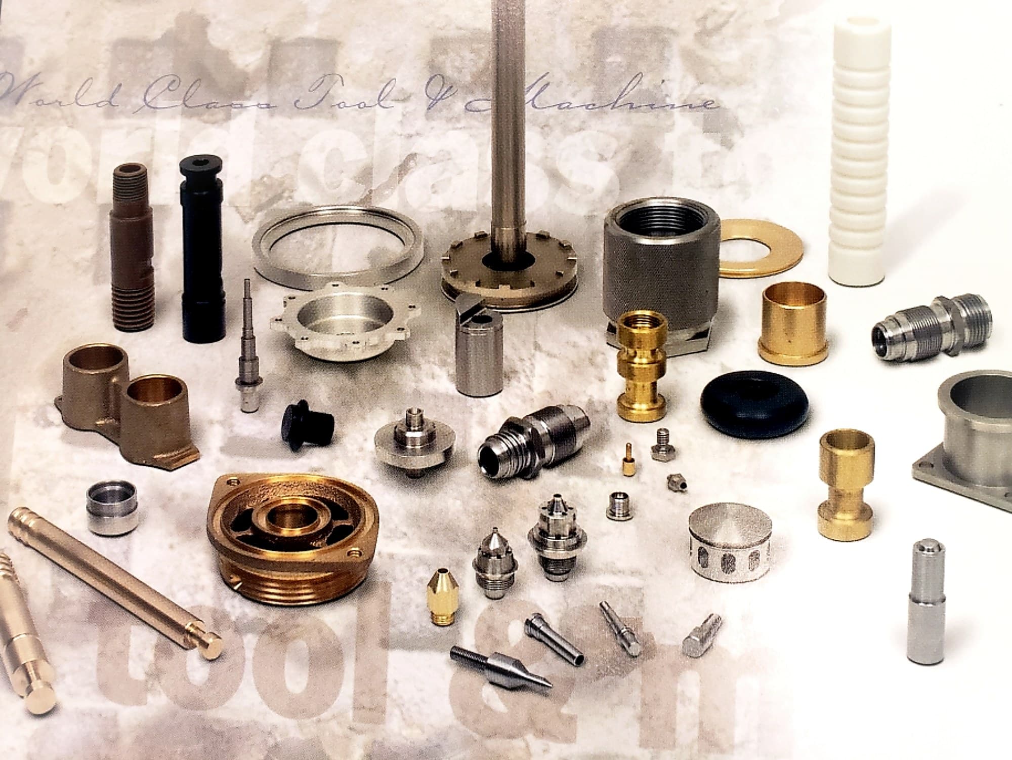Assorted precision machined components arranged for catalog display.